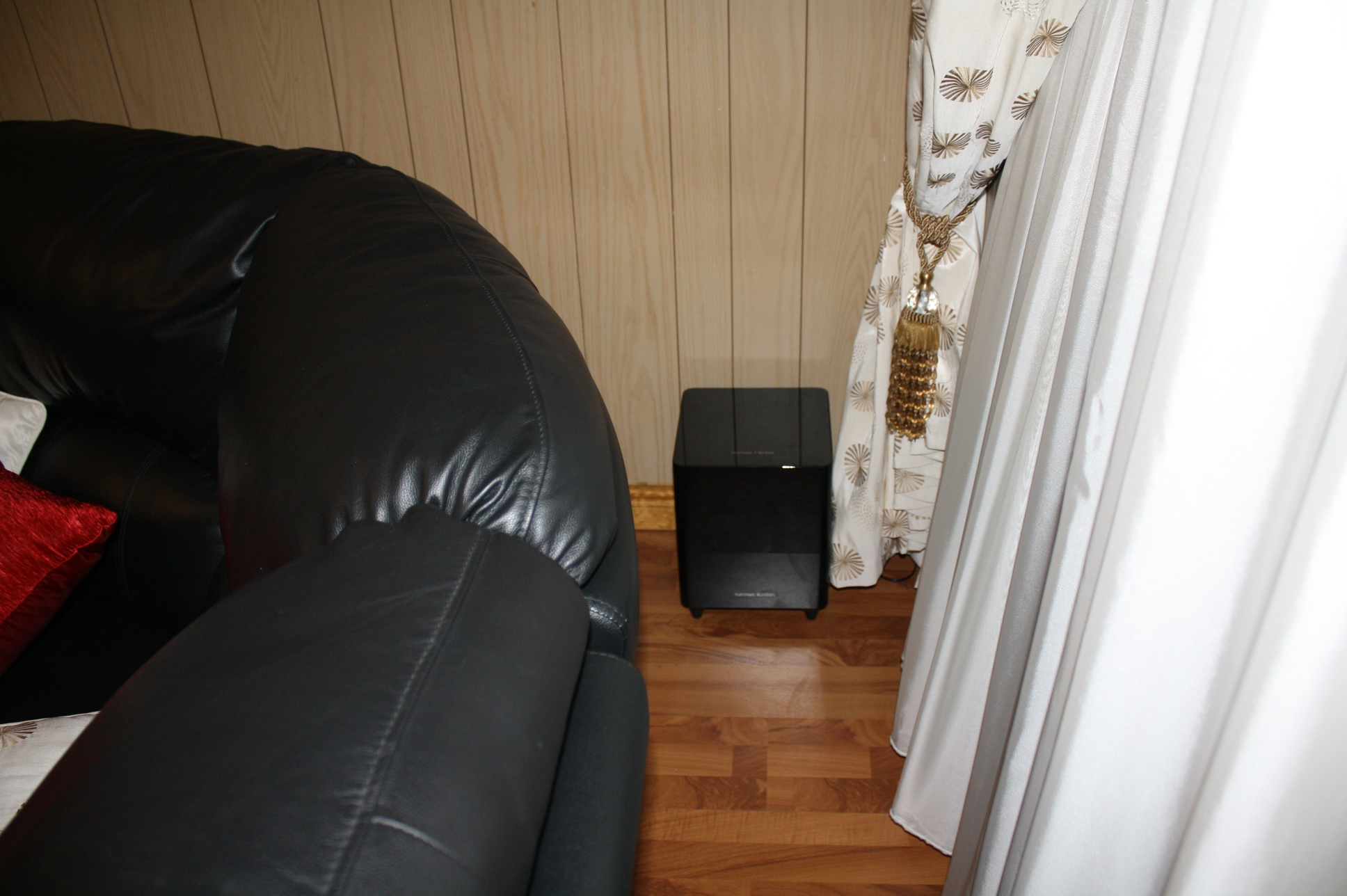 Subwoofer behind hot sale couch